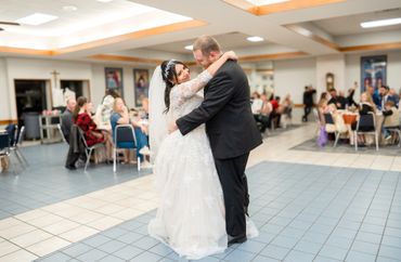 Bride and groom share a loving first dance at their wedding reception.