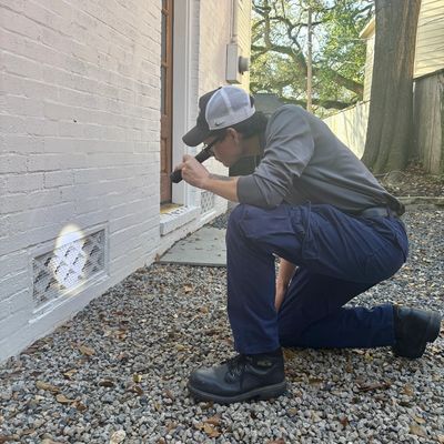 Pest control technician inspecting a Houston home for pest activity