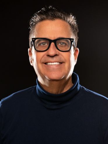 Man with glasses smiling
