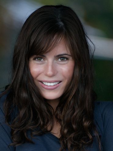 Woman with brown hair smiling.