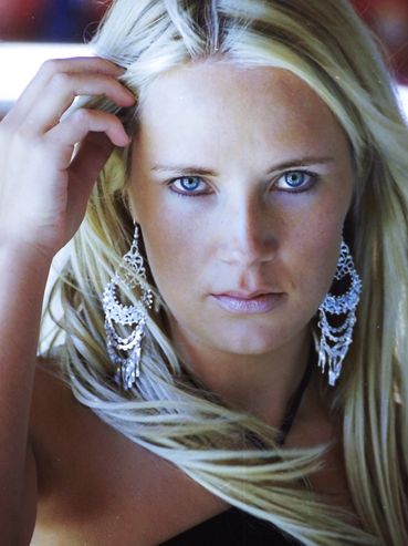 Blond model with blue eyes posing for a headshot