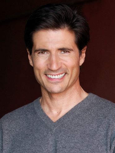 Man with brown hair smiling.