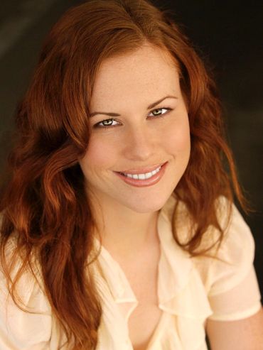 Girl with red hair smiling.