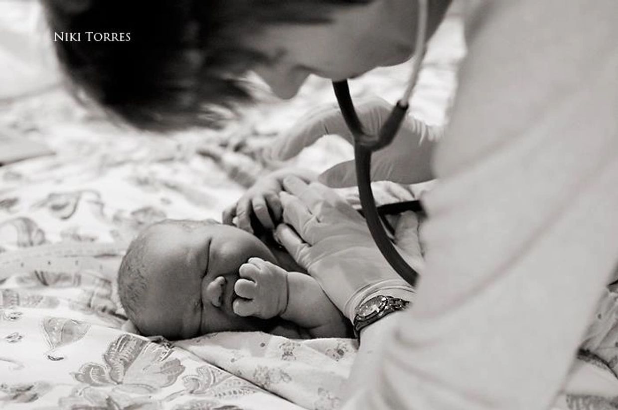 midwife examining baby