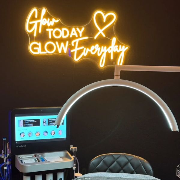 skincare treatment room with glowing neon sign.