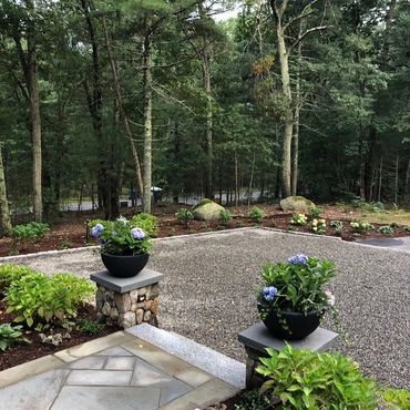 Bluestone walkway, granite steps, stone veneer, gravel driveway, cobblestone edging and lighting