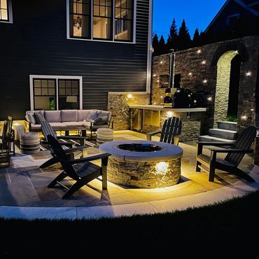 Stone fire pit, pizza oven, stone patio and steps, landscape lighting and sod lawn