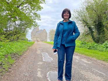 Woman standing on country road.