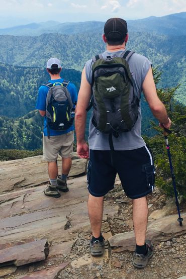 Two men hiking up mountain.