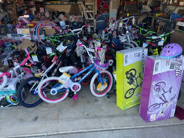 A cluttered garage filled with children's bicycles and bike accessories.