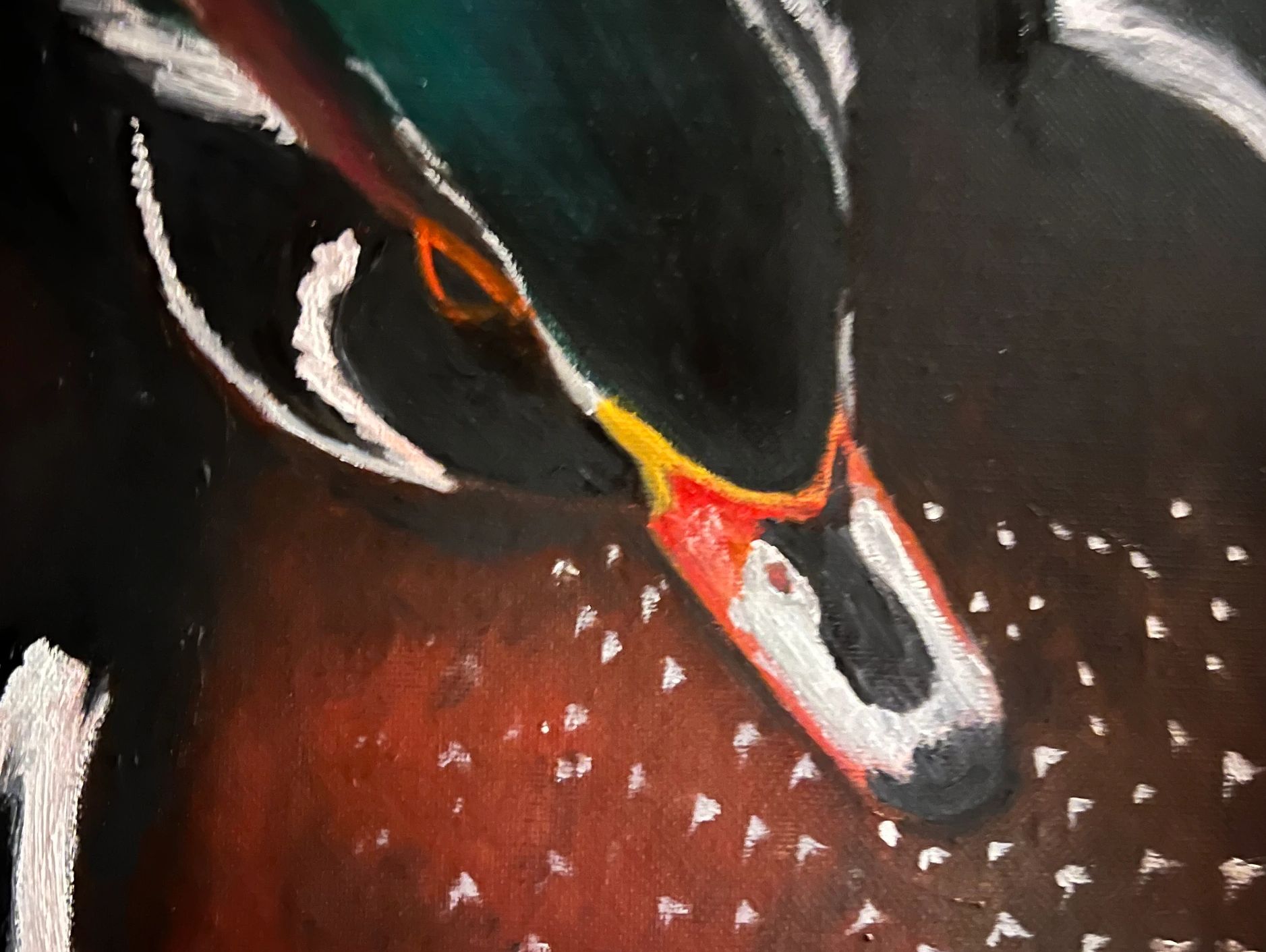 Close-up of a painted bird's head with vibrant colors.