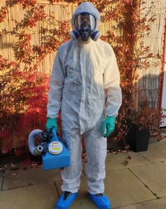 Pest Control technician in Personal protective equipment.