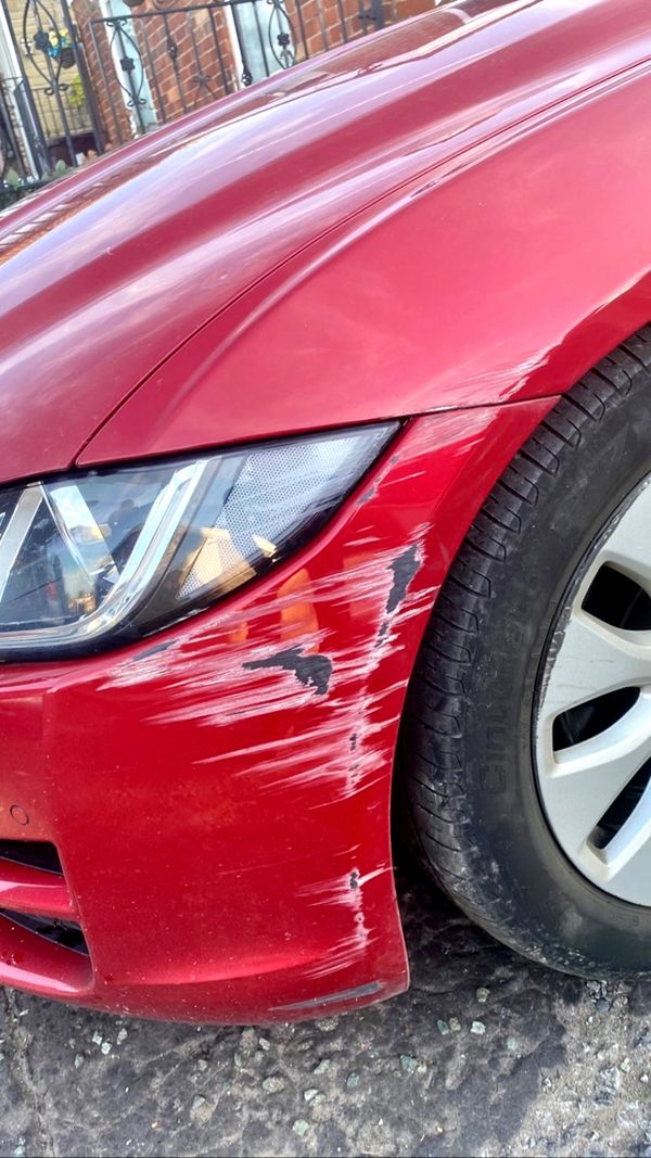 red jaguar car bumper scuff damage repair scratch