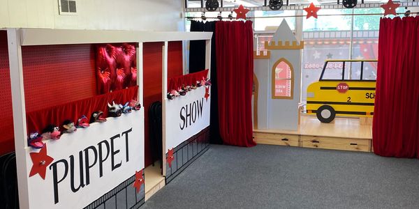 Spotlight has two puppet show stages and a grand stage with red curtains that adds that classic thea