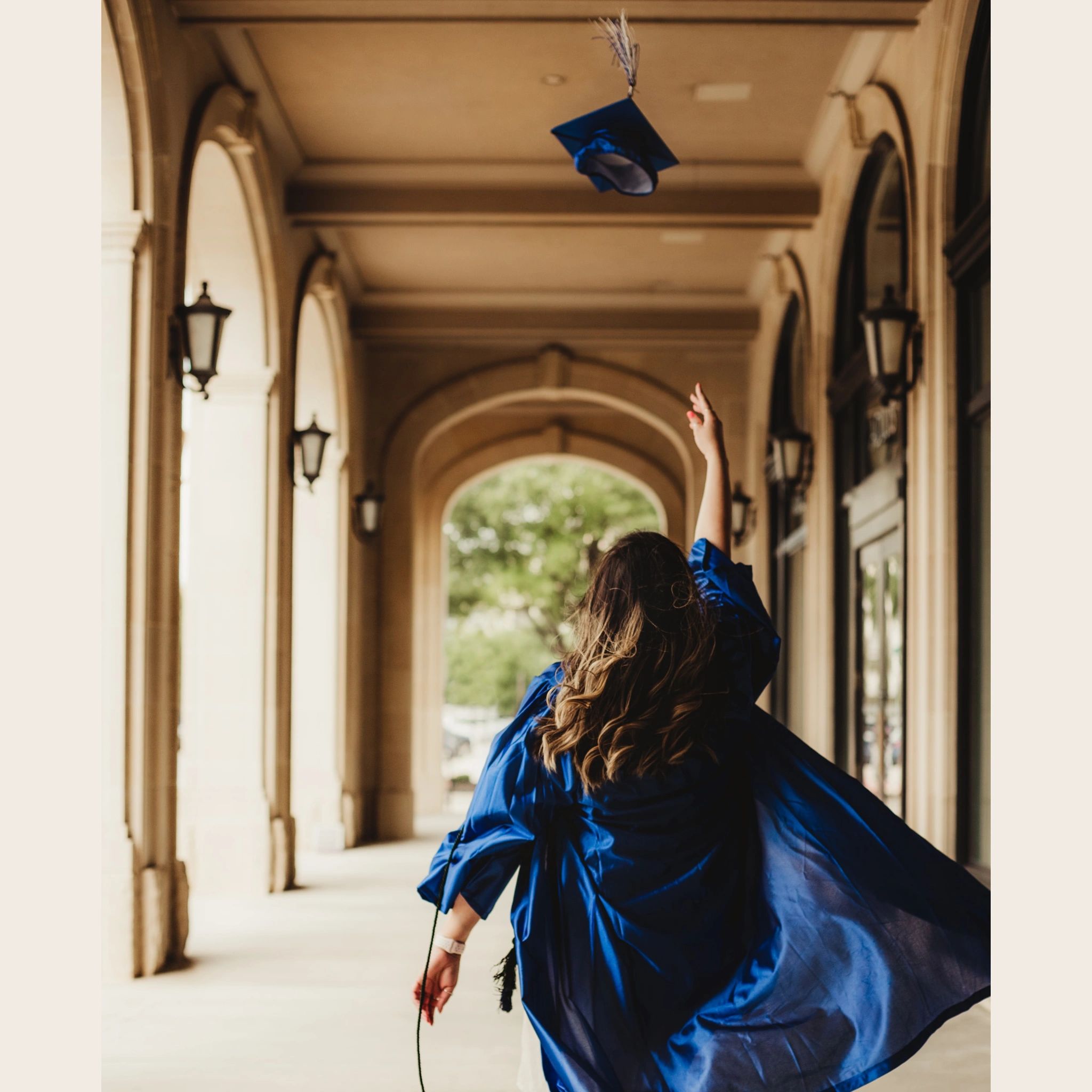 A female graduate tossing her cap in the air