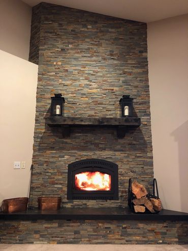 Rustic fireplace mantel on a stone fireplace