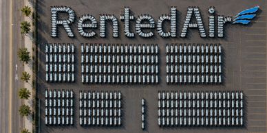 White vans arranged to spell "RentedAir" with a blue wing logo.