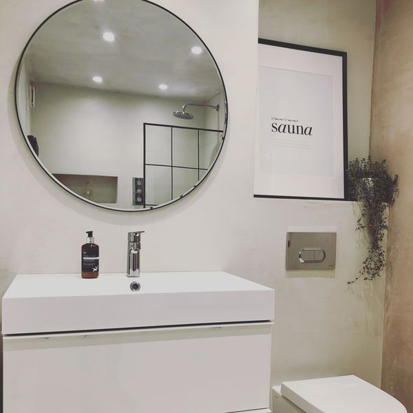 Sleek modern bathroom with custom vanity, round mirror, clean, minimalist design. Leamington spa