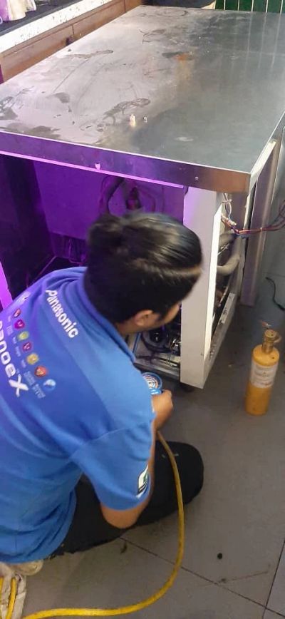 Technician repairing an appliance.
