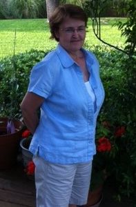 Close up shot of a lady in blue dress smiling at the camera