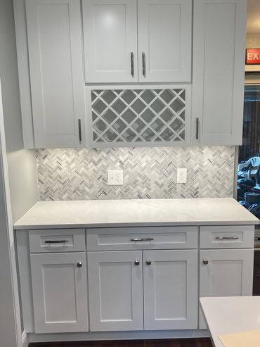 Custom waiter's station or services station with soft close cabinets, and wine rack.