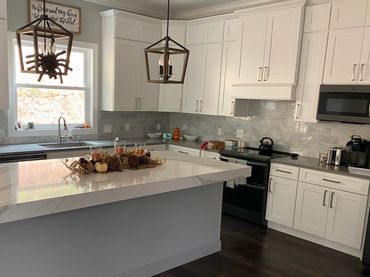 42" White shaker cabinets, upper wall cabinets, thick Cambria quartz countertops & hickory floor