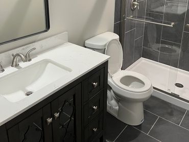Walking shower with frameless glass and oversized vanity.