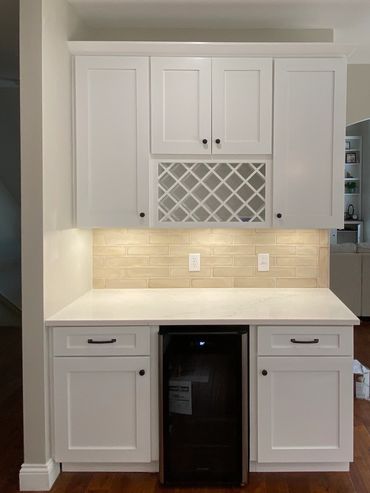 Custom bar waiter's station or services station with soft close cabinets, wine rack, and wine fridge