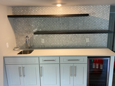 Wet bar, wine fridge, full-wall backsplash, floating shelves and white shaker soft close cabinets.