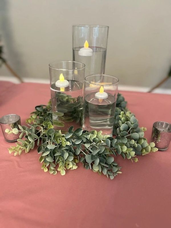 Ella's garden decor - floating candle three cylinders with greenery and silver votives