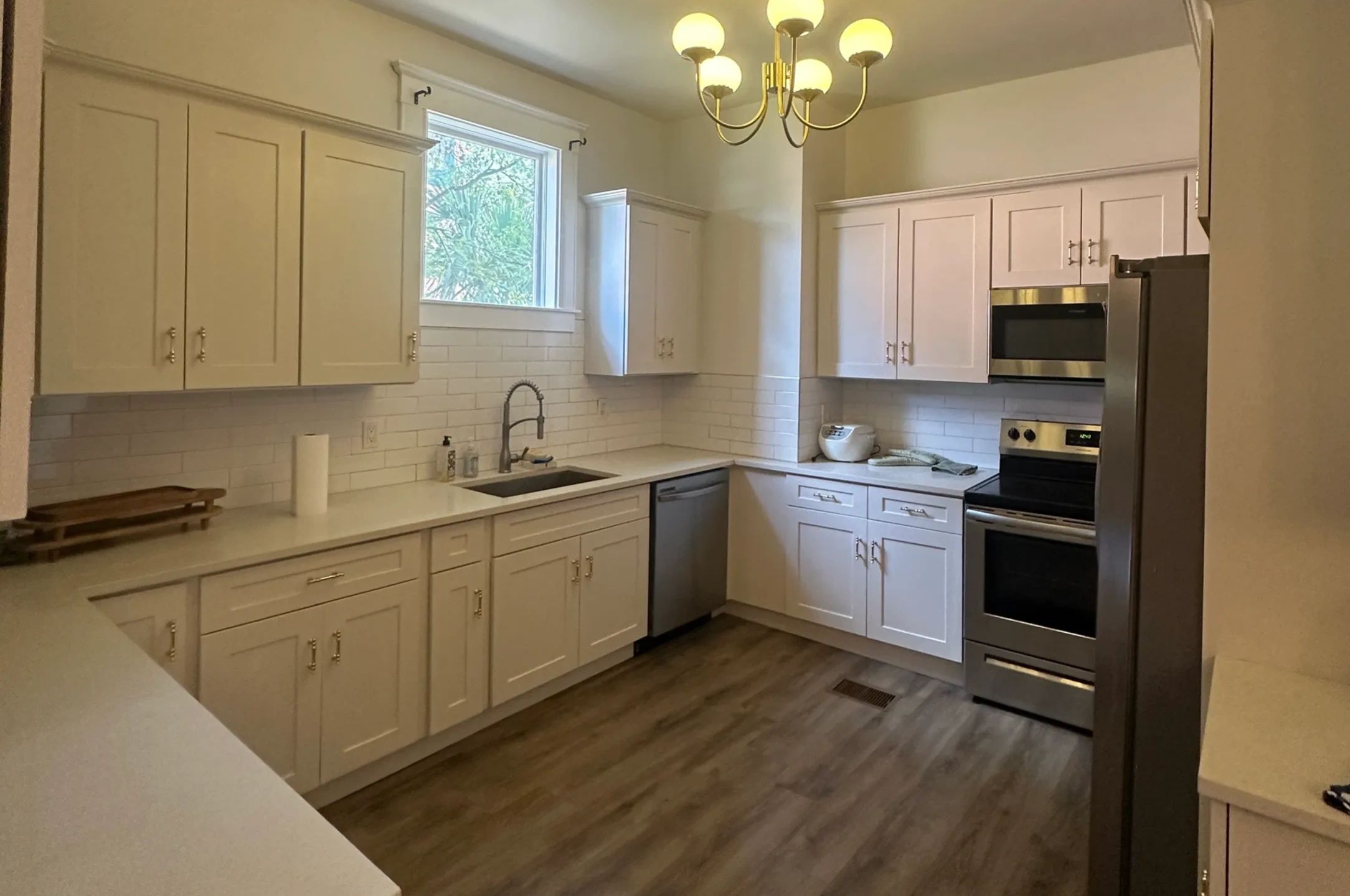 Kitchen cabinet painting, drywall repair & LVP floor install completed by Tool4Home Jacksonville FL