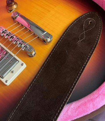 Les Paul guitar with a suede comfy guitar strap.