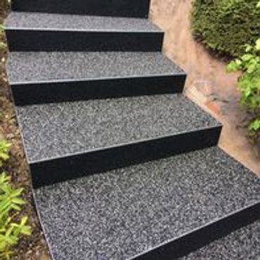 Outdoor steps with textured, speckled non-slip surface.