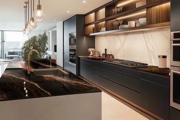 Modern kitchen with dark countertops and warm wood accents.