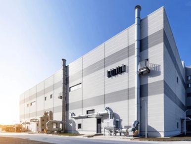 Modern industrial building under clear sky.
