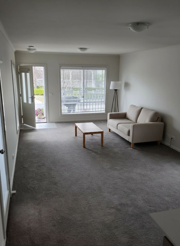 Minimalist living room with sofa and coffee table.