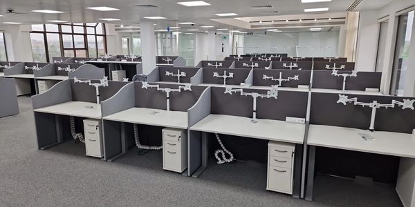 Empty modern office cubicles without chairs or computers.