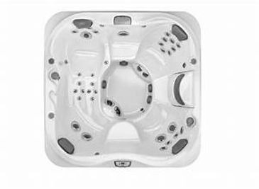 Top view of a white square hot tub with multiple seats and jets.