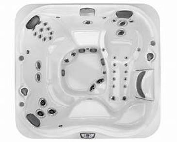 Top view of a white multi-seat hot tub with multiple jets.