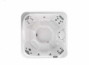 Top view of a white square hot tub with multiple jets.