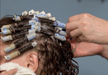 Person's hair set with perm rods and foam.