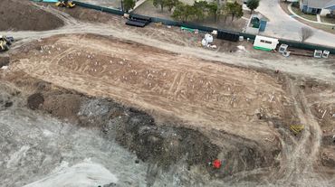 A construction site with soil and foundation markers in place.