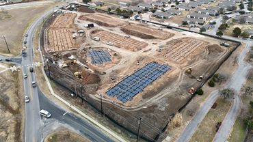 Aerial view of a residential construction site with foundation work underway.