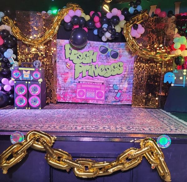 Fresh Princess-themed party stage with colorful decorations.