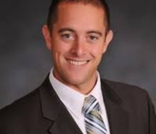 Professional man in a suit smiling.