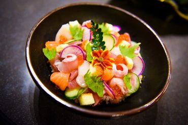 top view of bara chirashi bowl with sake maguro shiro maguro hamachi hirame hotate ikura and tamago