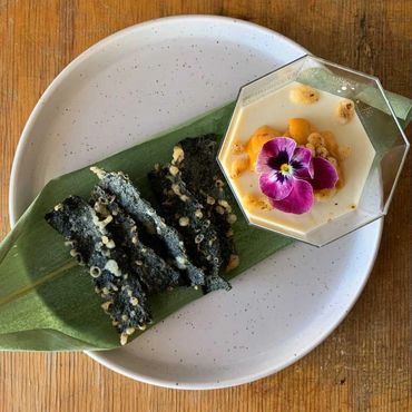 top view of uni panna cotta with fresh hokkaido japanese uni and crispy nori seaweed chips