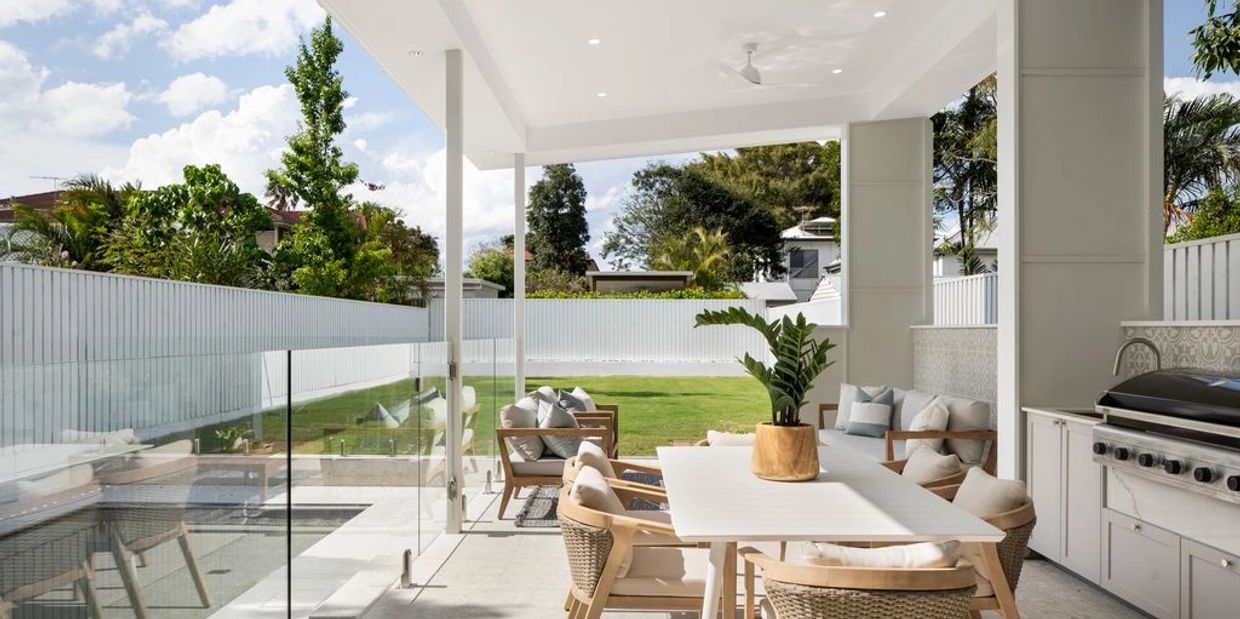 Modern outdoor patio with dining area and pool.