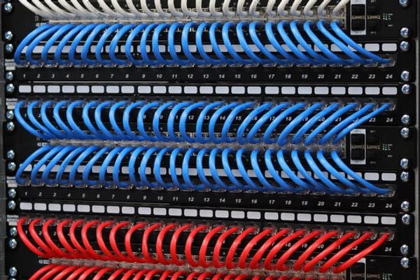 Organized patch panel with blue and red cables.
