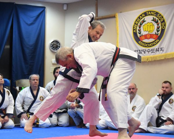 Martial artists sparring during a Taekwondo class.